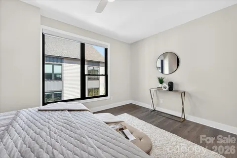 a bedroom with a bed and a large window