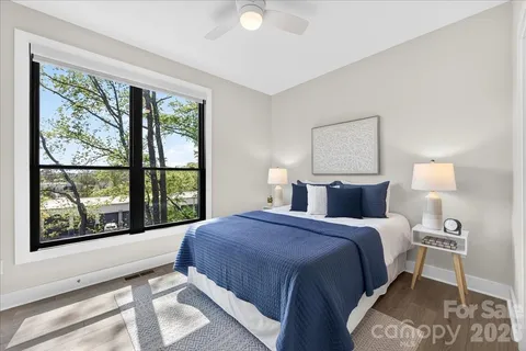 a bedroom with a bed and a large window
