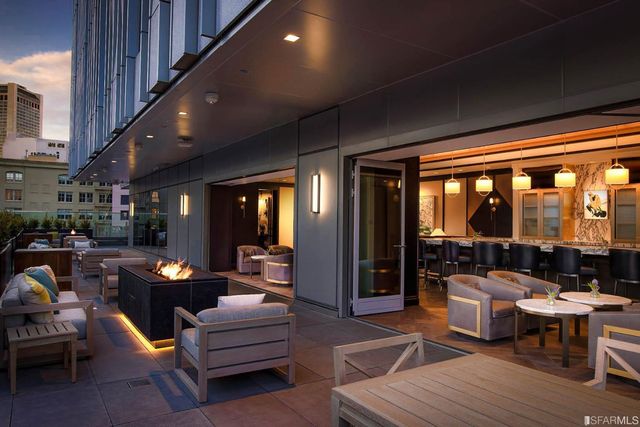 a living room with furniture and large windows