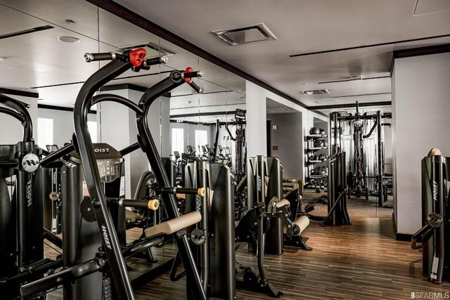 a view of a room with lots of gym equipment