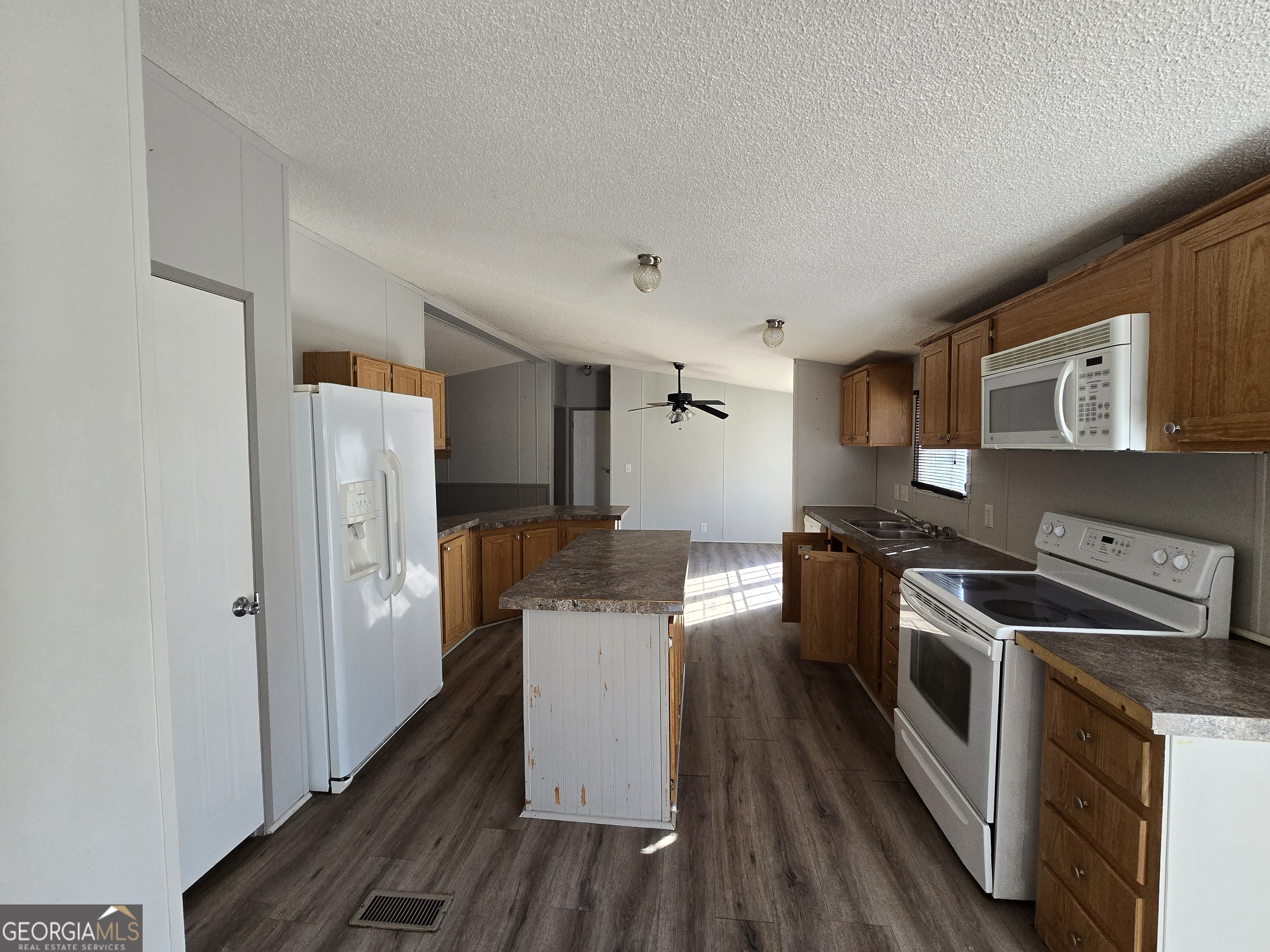 122 Puckett Road Southeast Emerson, GA 30137 - Photo 2 of 17 a kitchen with stainless steel appliances a stove a refrigerator a sink and wooden floor