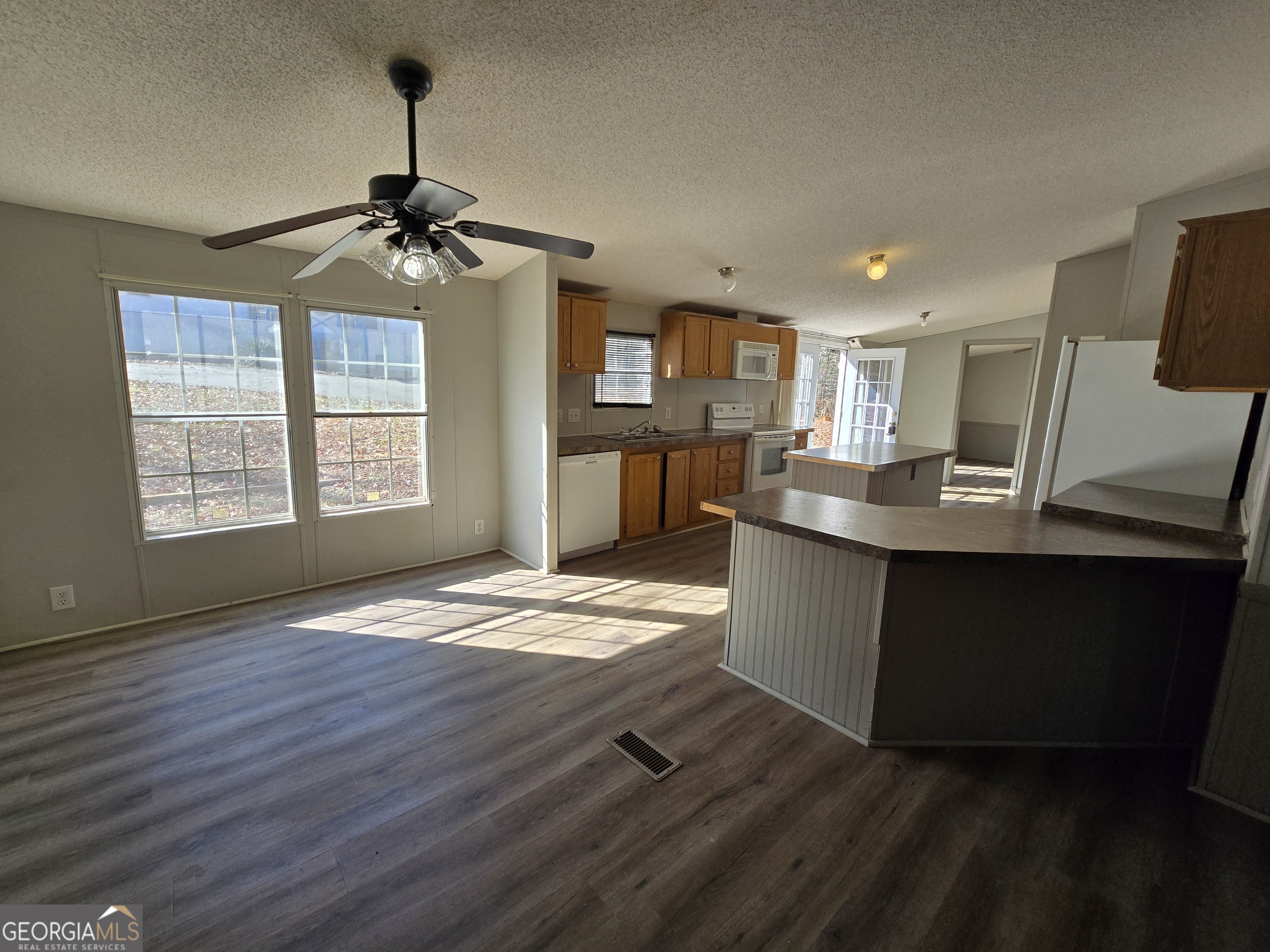 122 Puckett Road Southeast Emerson, GA 30137 - Photo 3 of 17 a kitchen with stainless steel appliances granite countertop a sink a stove top oven a counter space and cabinets