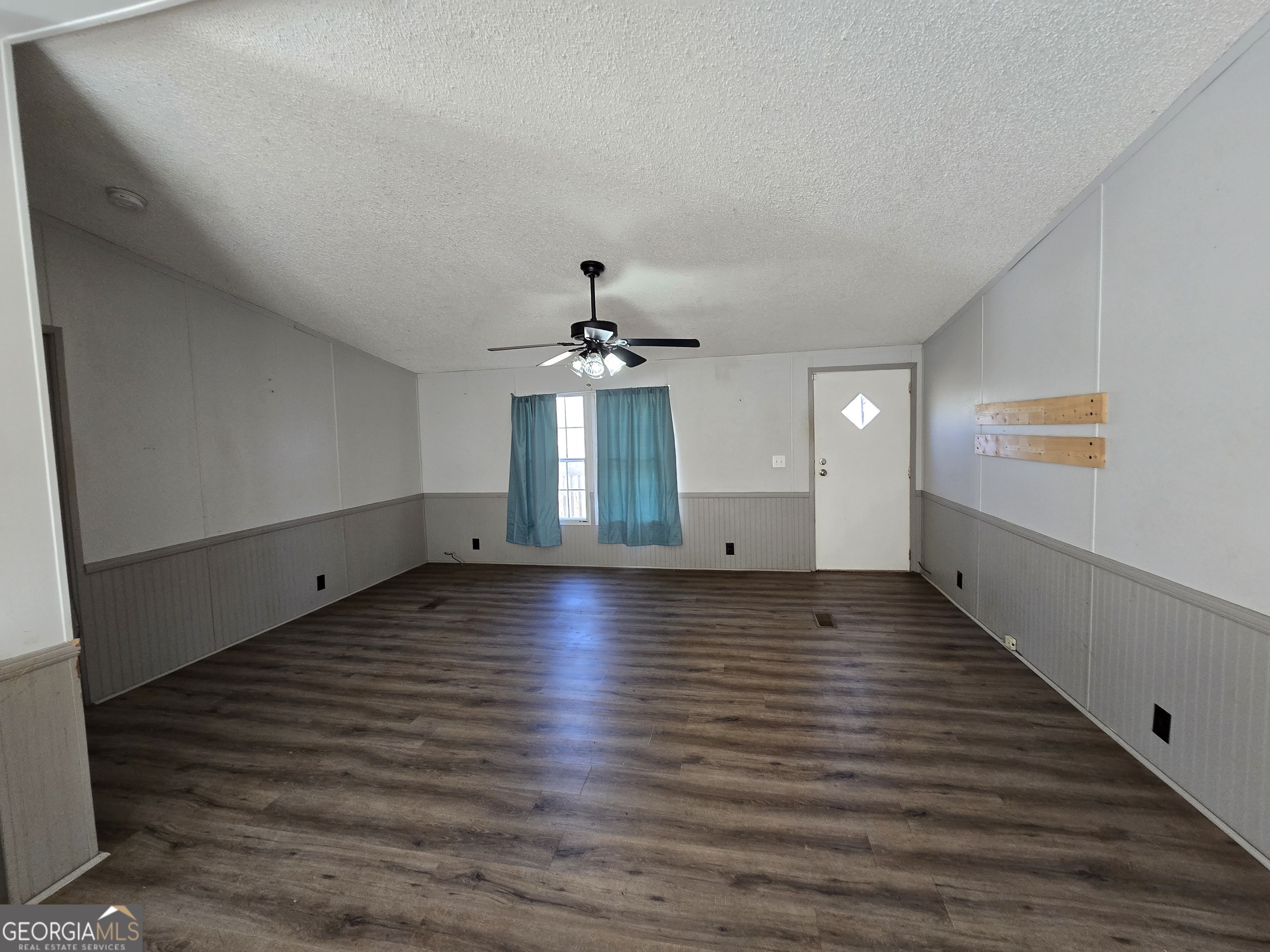 122 Puckett Road Southeast Emerson, GA 30137 - Photo 5 of 17 an empty room with wooden floor chandelier and windows