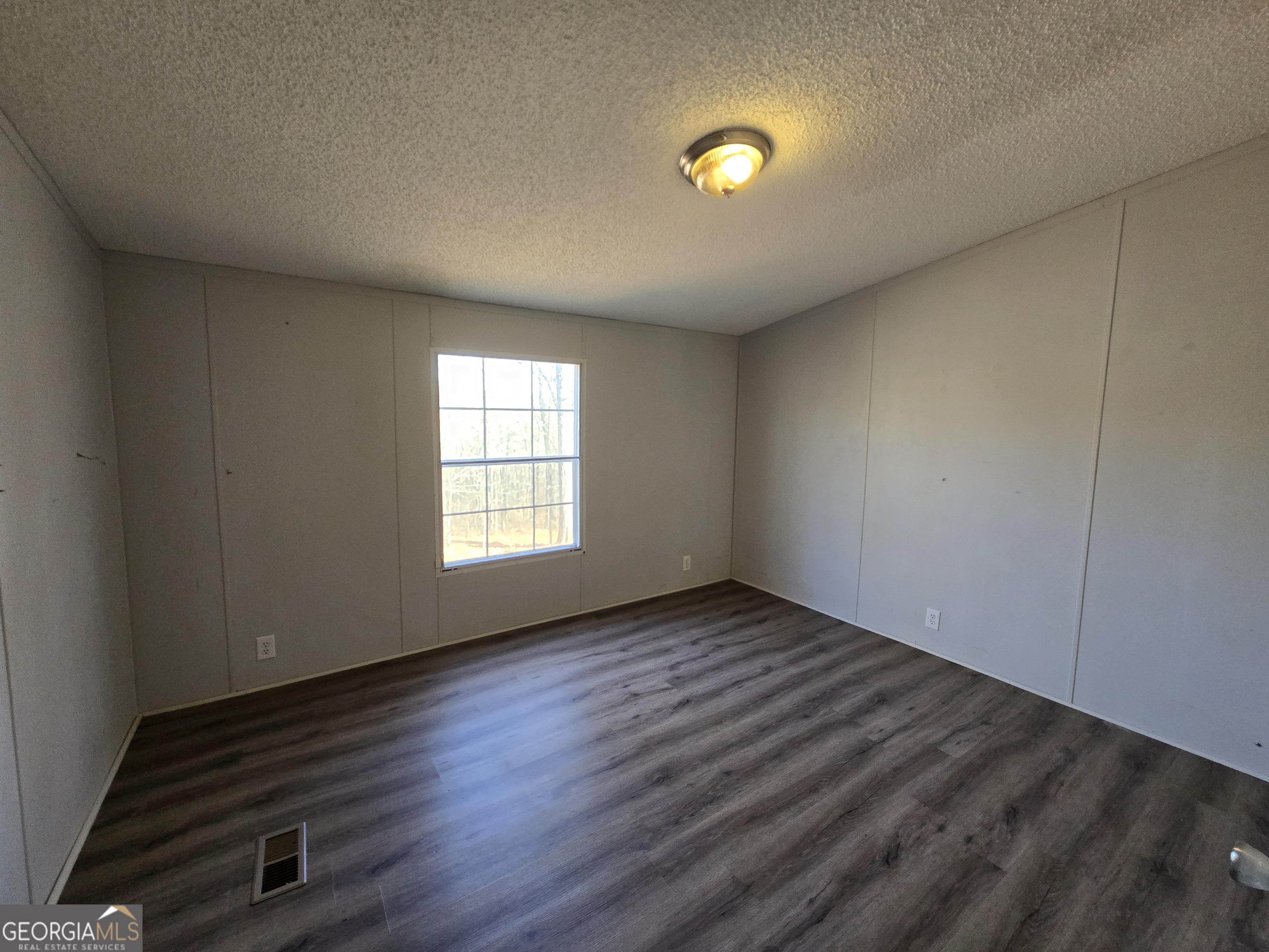 122 Puckett Road Southeast Emerson, GA 30137 - Photo 6 of 17 an empty room with wooden floor and windows