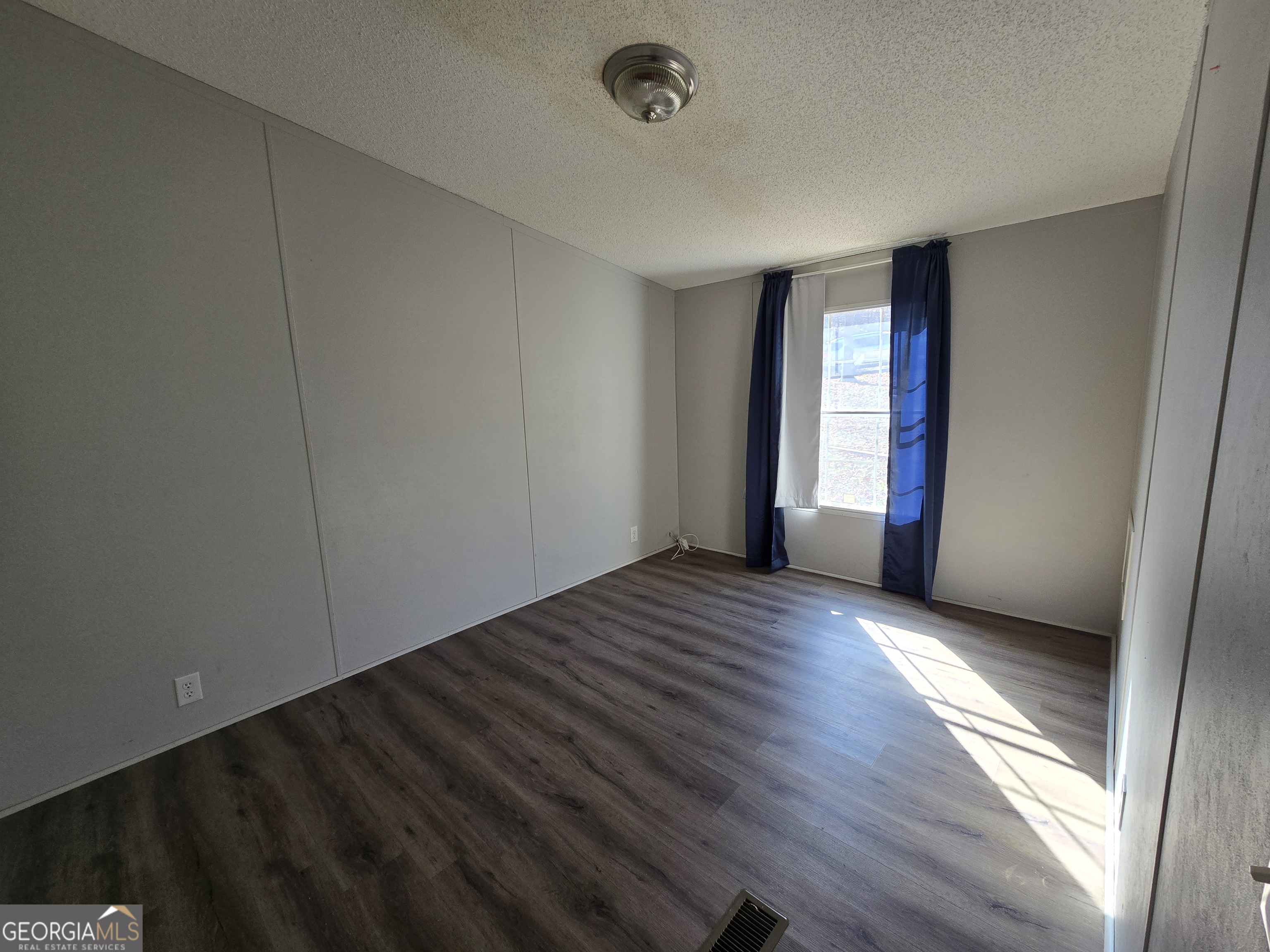 122 Puckett Road Southeast Emerson, GA 30137 - Photo 7 of 17 a view of an empty room with wooden floor and a window