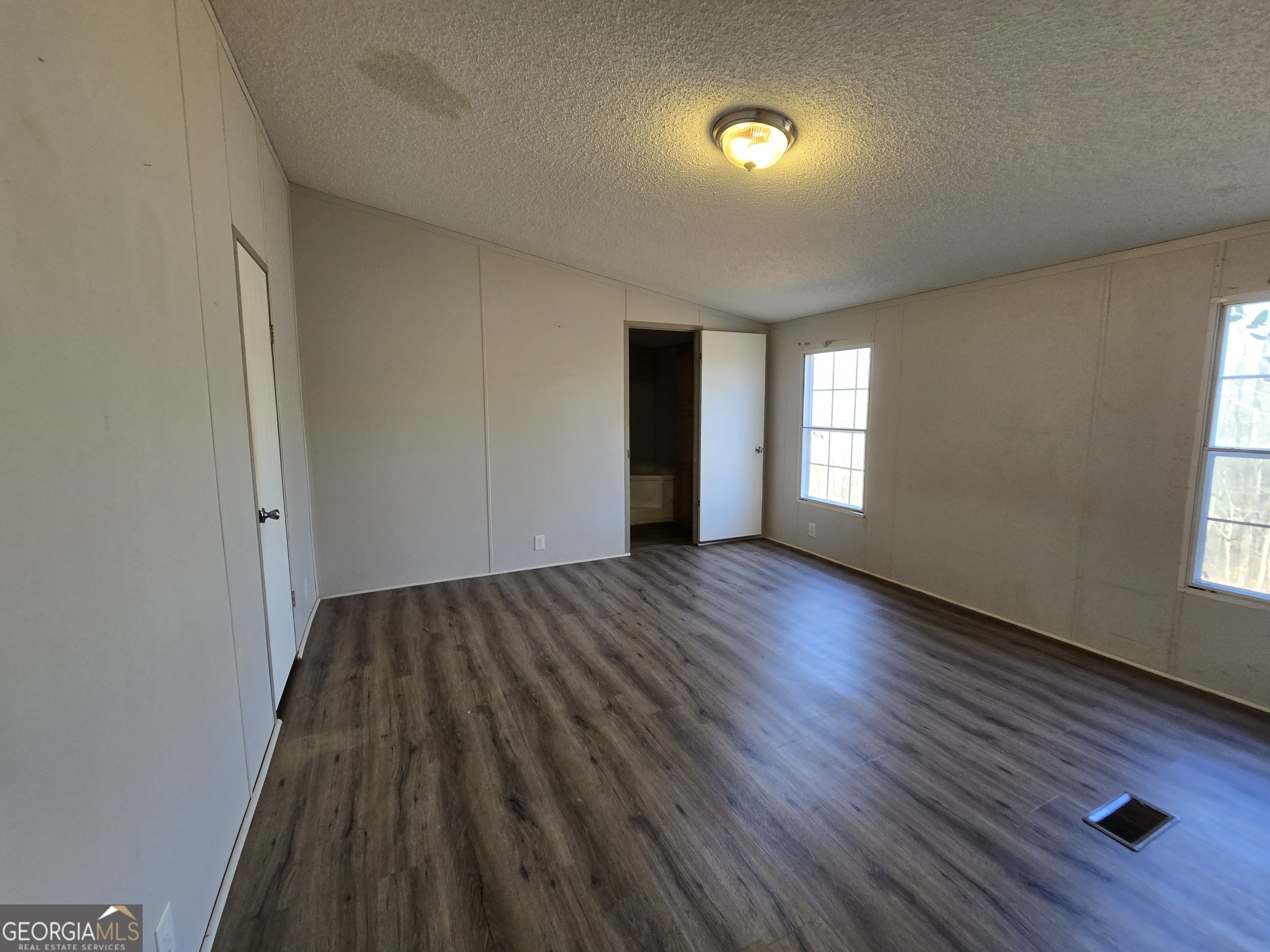122 Puckett Road Southeast Emerson, GA 30137 - Photo 8 of 17 an empty room with wooden floor and windows