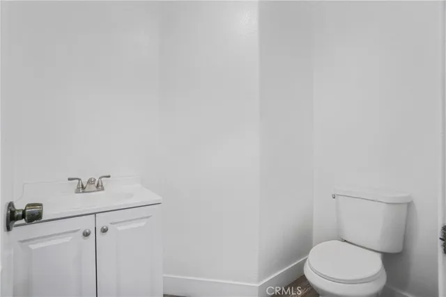 a white toilet sitting next to a white sink