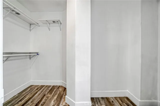 a view of walk in closet with empty racks