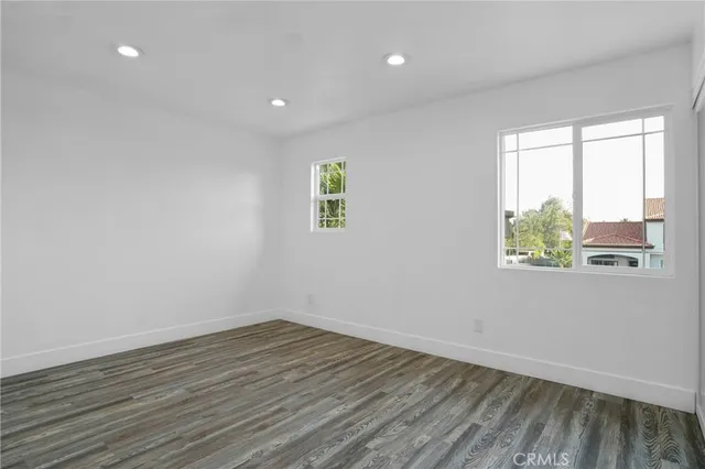 a view of room with window and wooden floor