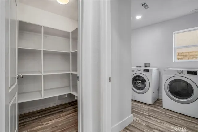 a utility room with sink dryer and washer