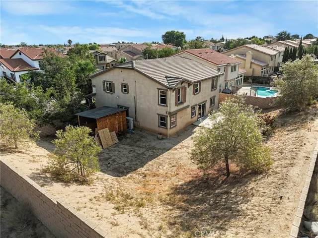 a aerial view of a house with a yard and large tree