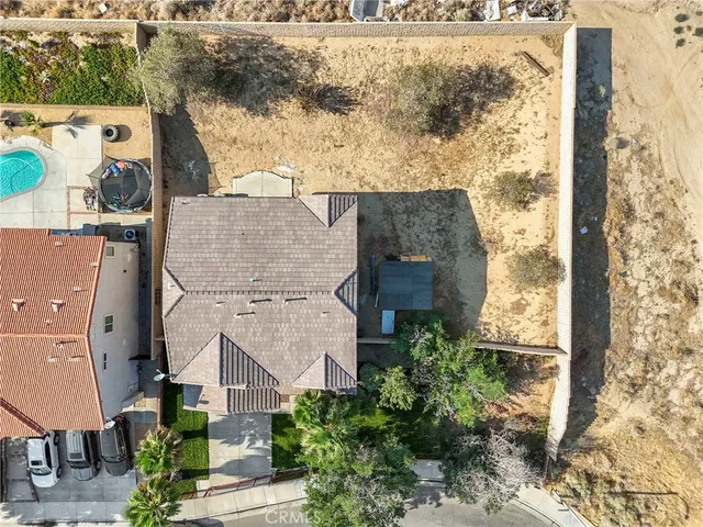 an aerial view of a house with a yard