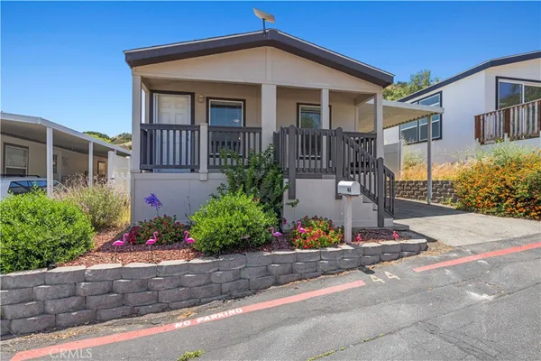 a front view of a house having a yard