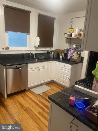a kitchen with stainless steel appliances granite countertop a sink dishwasher stove and cabinets