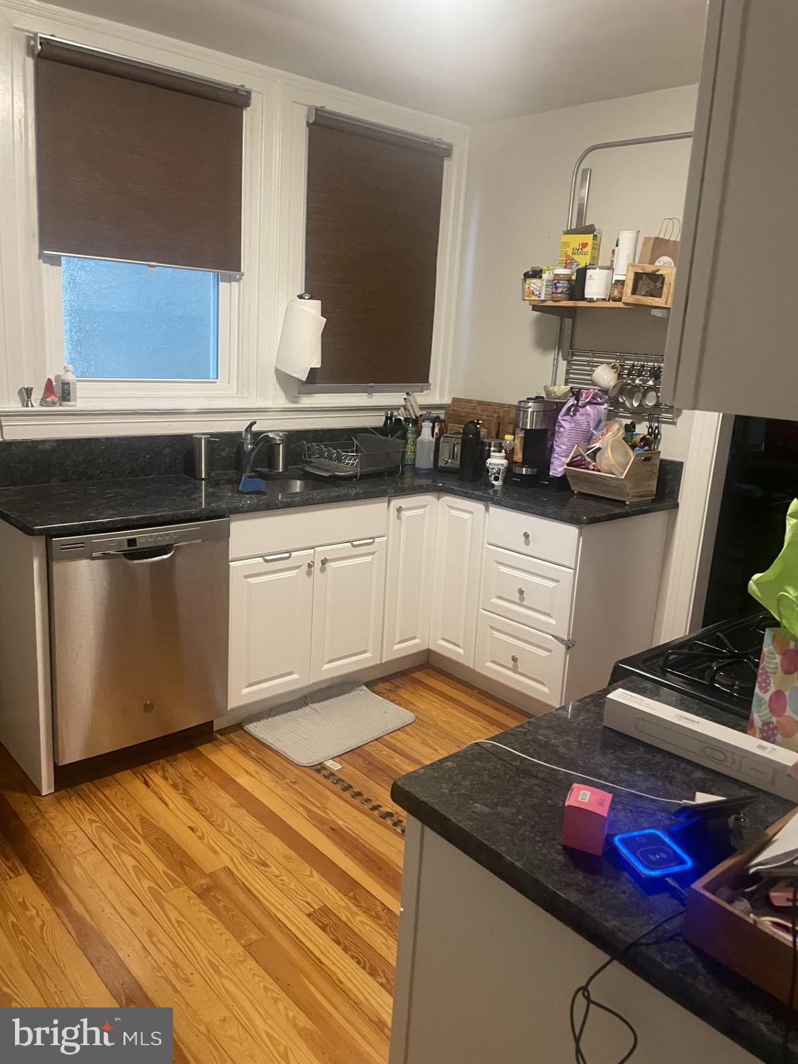 127 State Street, Unit 2 Kennett Square, PA 19348 - Photo 6 of 11 a kitchen with stainless steel appliances granite countertop a sink dishwasher stove and cabinets
