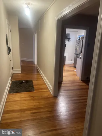 a view of a hallway view with wooden floor and staircase