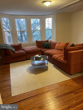a living room with furniture window and wooden floor