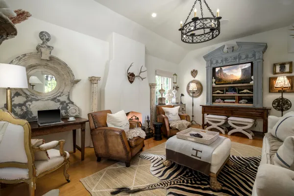 a bedroom with a bed and a chandelier