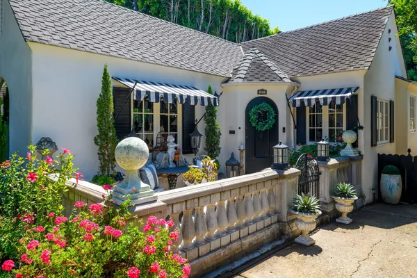 a view of a patio with chairs and potted plants