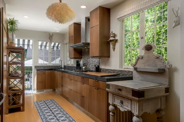 a living room with furniture a chandelier and a floor to ceiling window