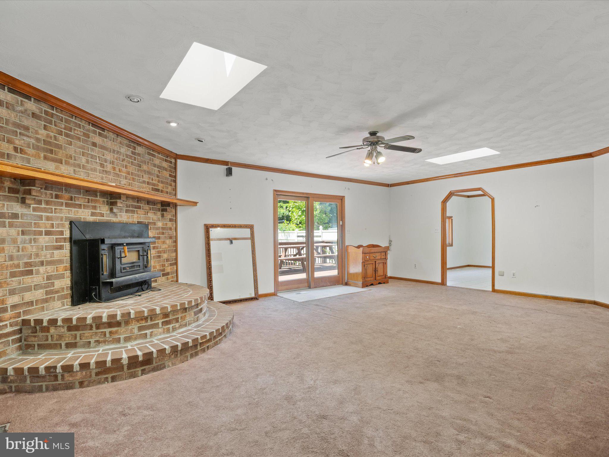 4340 Huntingtown Road Huntingtown, MD 20639 - Photo 11 of 42 a view of an empty room with a fireplace and a window