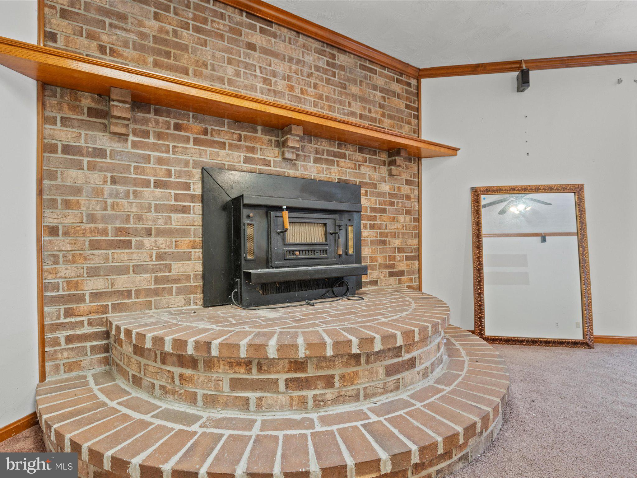 4340 Huntingtown Road Huntingtown, MD 20639 - Photo 12 of 42 a view of a fireplace with wooden floor