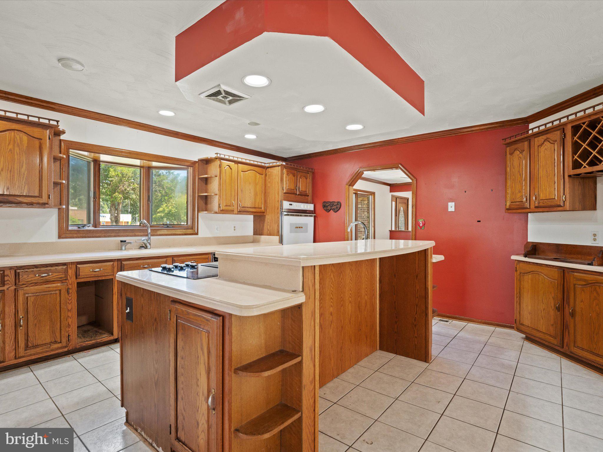 4340 Huntingtown Road Huntingtown, MD 20639 - Photo 18 of 42 a kitchen with stainless steel appliances granite countertop a stove a sink and a refrigerator