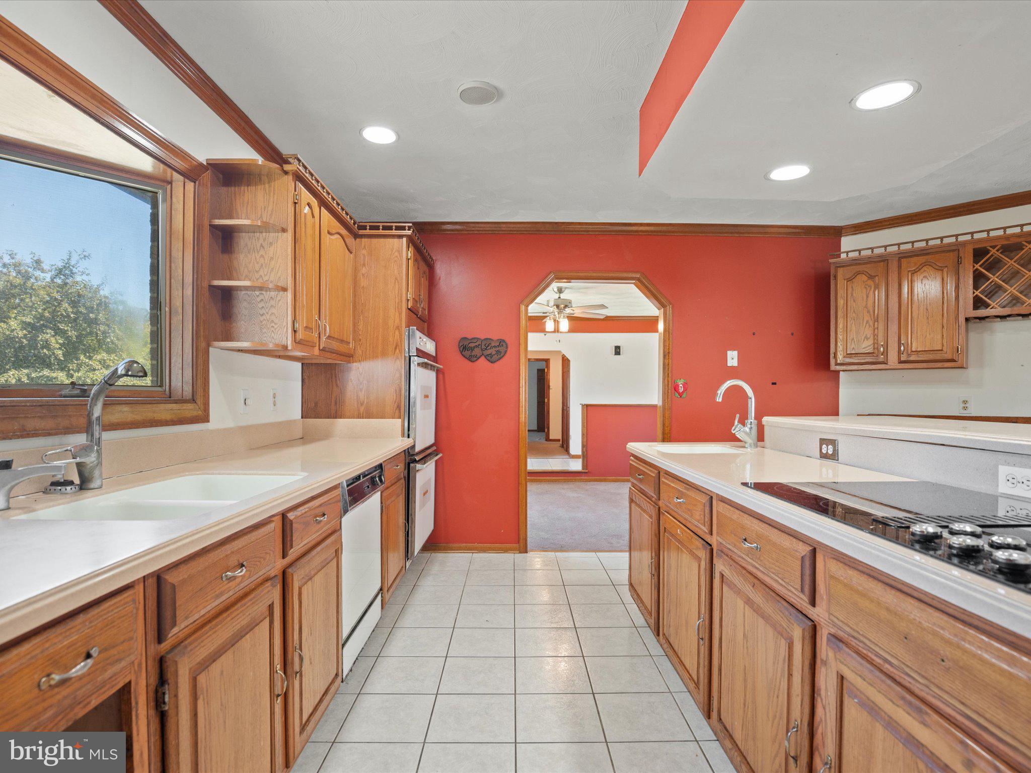4340 Huntingtown Road Huntingtown, MD 20639 - Photo 20 of 42 a kitchen with stainless steel appliances granite countertop a sink and a wooden cabinets