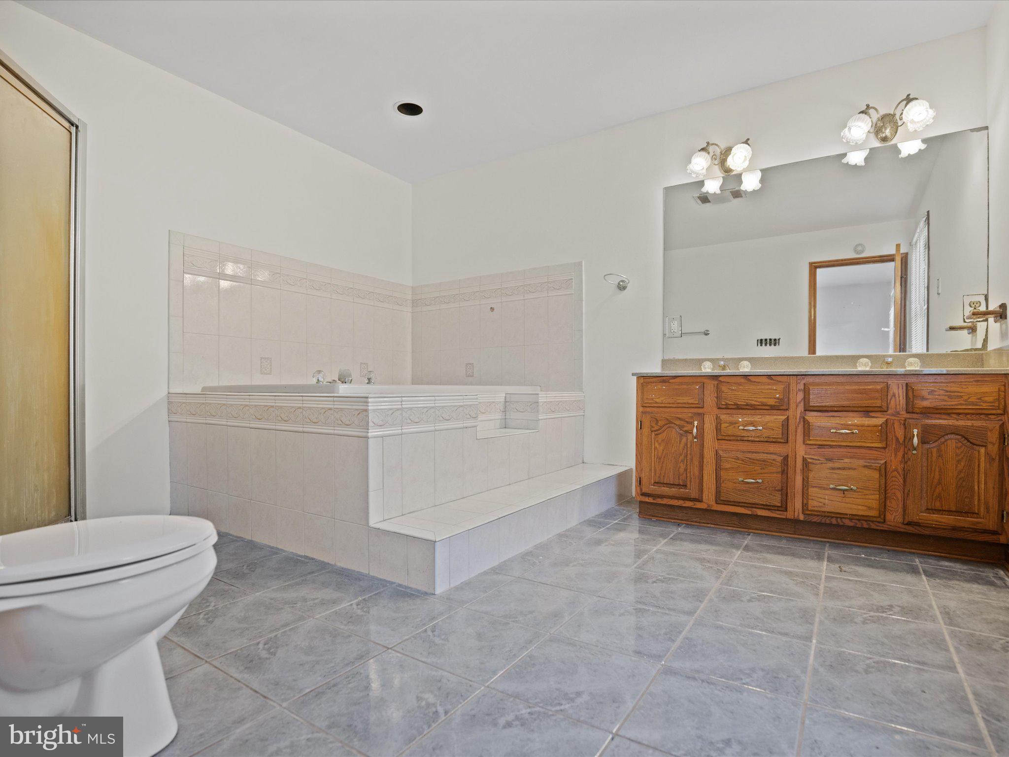 4340 Huntingtown Road Huntingtown, MD 20639 - Photo 30 of 42 a bathroom with a sink a toilet and mirror