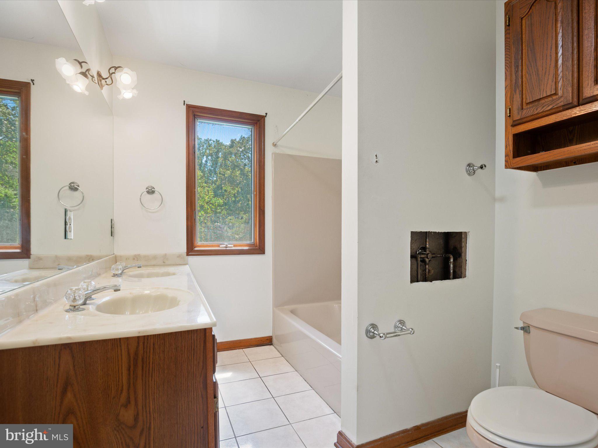 4340 Huntingtown Road Huntingtown, MD 20639 - Photo 33 of 42 a bathroom with a sink a toilet and shower