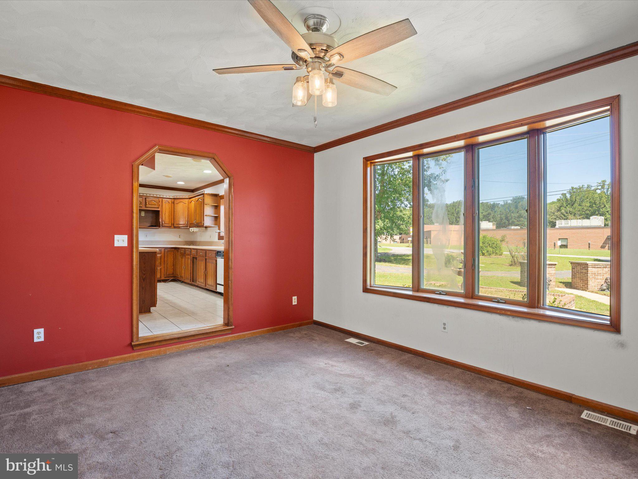 4340 Huntingtown Road Huntingtown, MD 20639 - Photo 9 of 42 an empty room with windows and ceiling fan