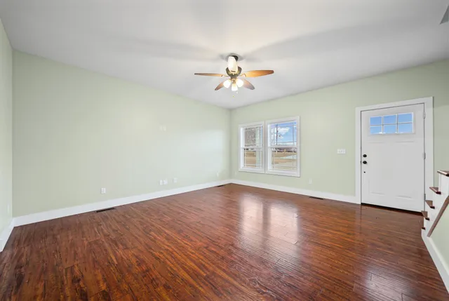 wooden floor in an empty room with a window