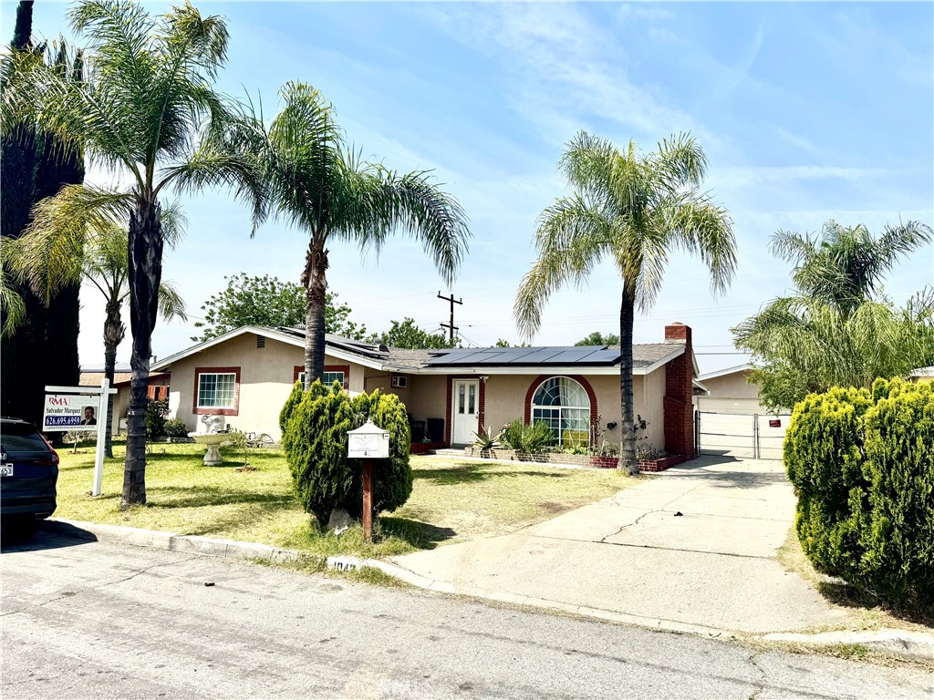 1042 North Alice Avenue Rialto, CA 92376 - Photo 1 of 31 a front view of a house with a garden