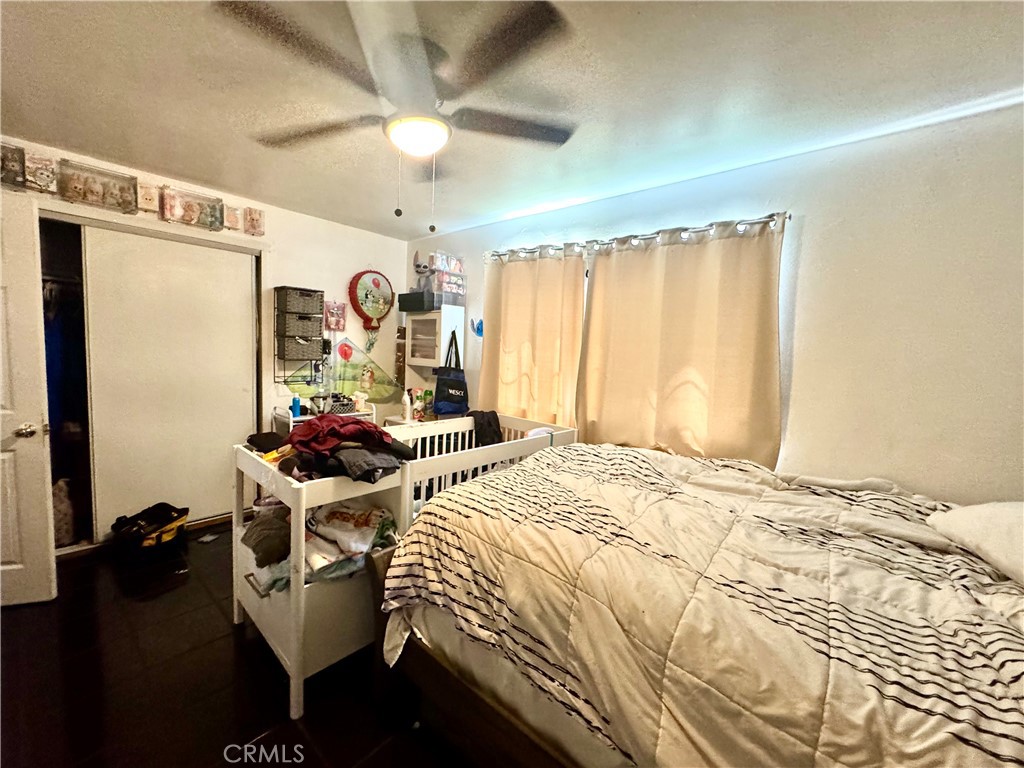 1042 North Alice Avenue Rialto, CA 92376 - Photo 12 of 31 a bedroom with a bed and a chandelier