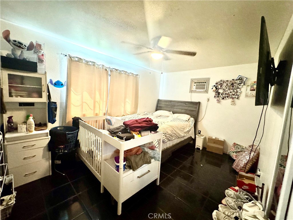 1042 North Alice Avenue Rialto, CA 92376 - Photo 13 of 31 a bed room with a bed window and a television