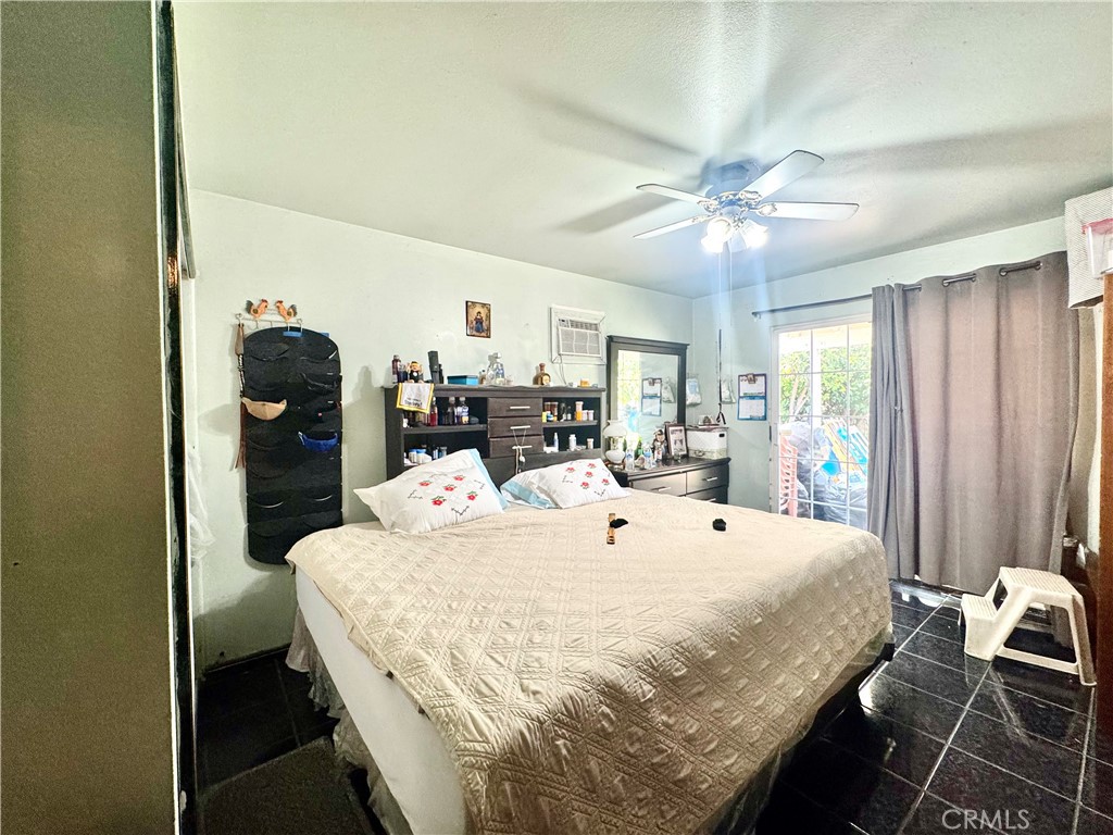 1042 North Alice Avenue Rialto, CA 92376 - Photo 15 of 31 a bed room with a bed and a chandelier
