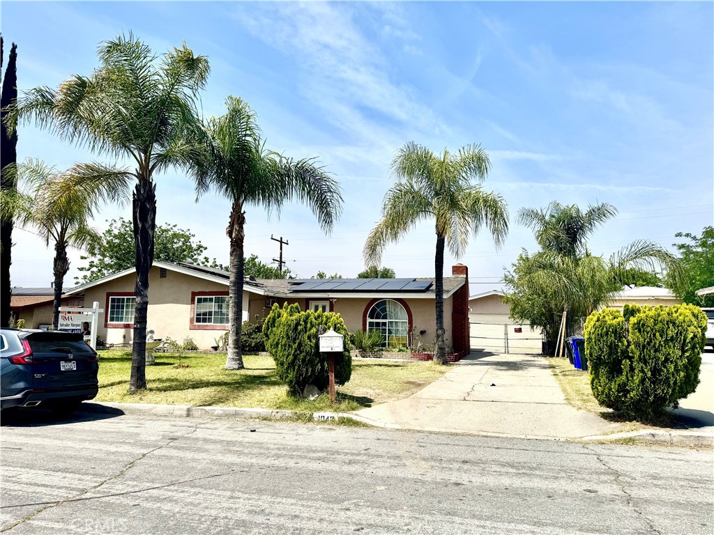 1042 North Alice Avenue Rialto, CA 92376 - Photo 2 of 31 a front view of a house with garden and parking