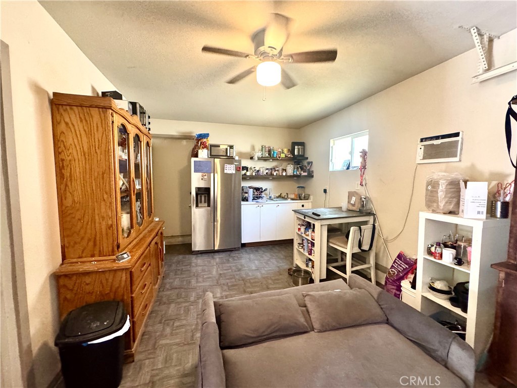 1042 North Alice Avenue Rialto, CA 92376 - Photo 29 of 31 a living room with furniture a air conditioner and a window
