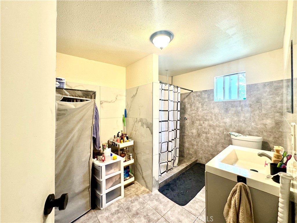 1042 North Alice Avenue Rialto, CA 92376 - Photo 31 of 31 a bathroom with a sink and a shower
