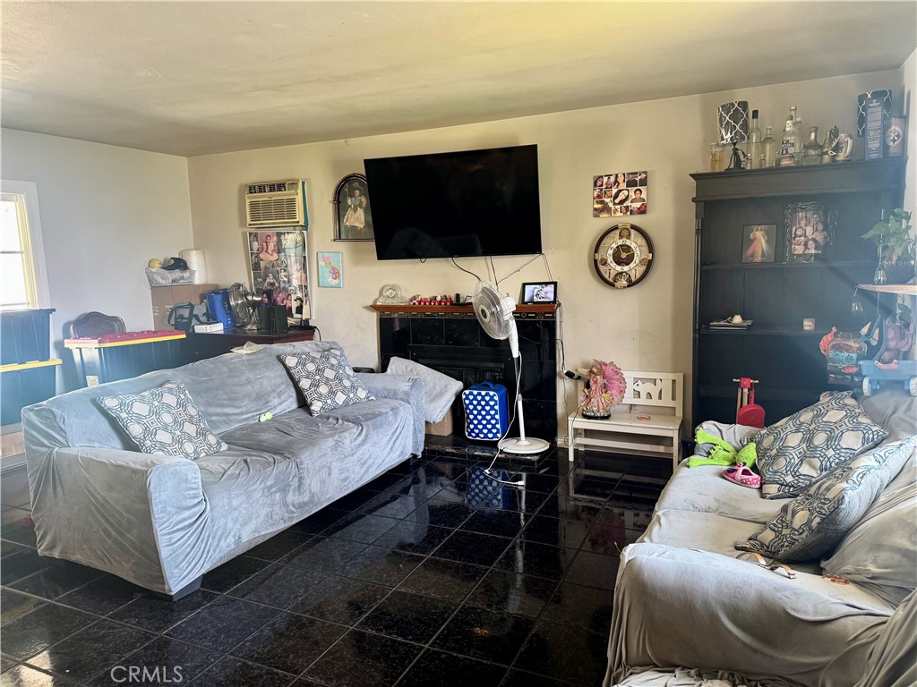1042 North Alice Avenue Rialto, CA 92376 - Photo 6 of 31 a living room with furniture and a flat screen tv