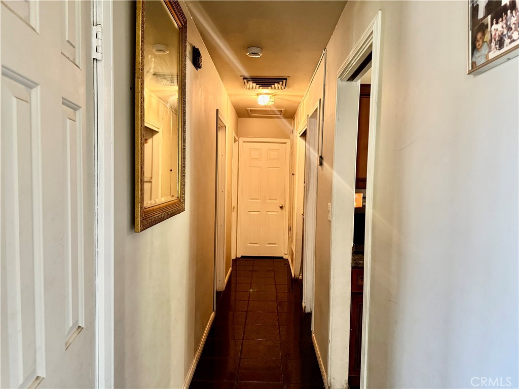 1042 North Alice Avenue Rialto, CA 92376 - Photo 8 of 31 a view of a hallway with wooden floor and staircase