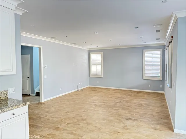 a view of an empty room with window and cabinet