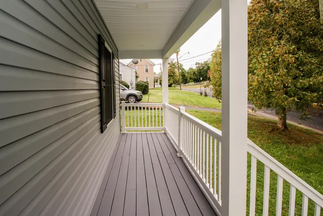 a view of a balcony with wooden floor
