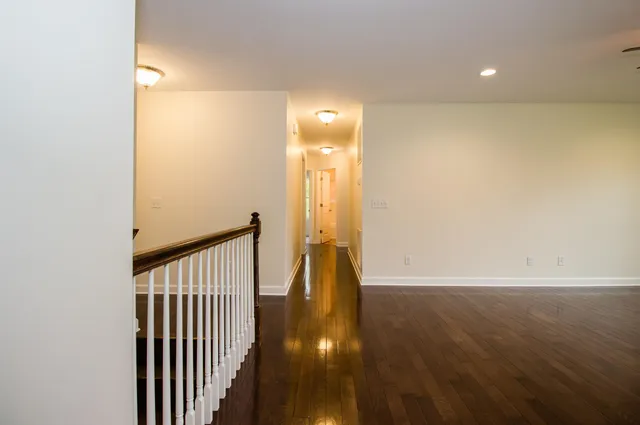 a view of hallway with wooden floor