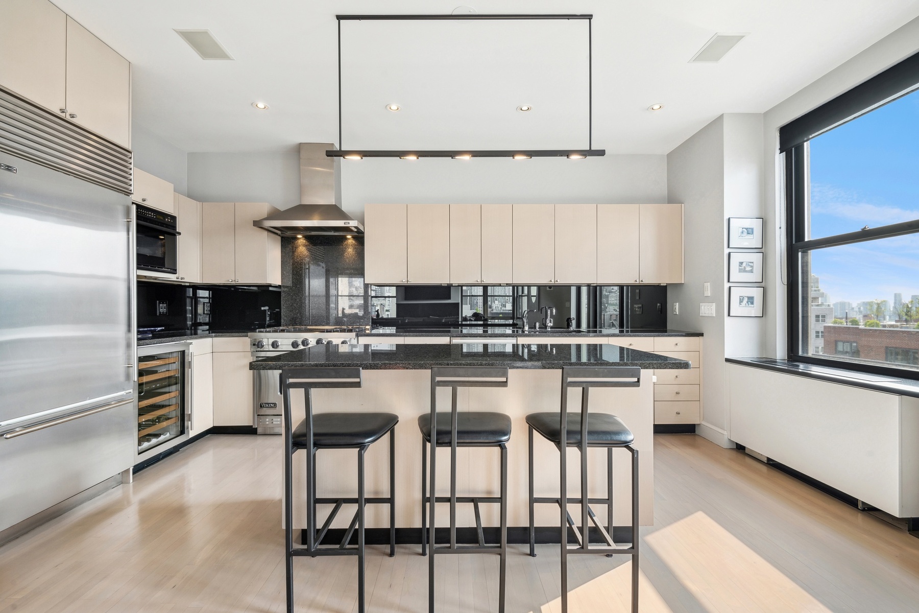 65 West 13th Street, Unit PH1AB Manhattan, NY 10011 - Photo 21 of 27 a kitchen with stainless steel appliances kitchen island granite countertop a sink and cabinets