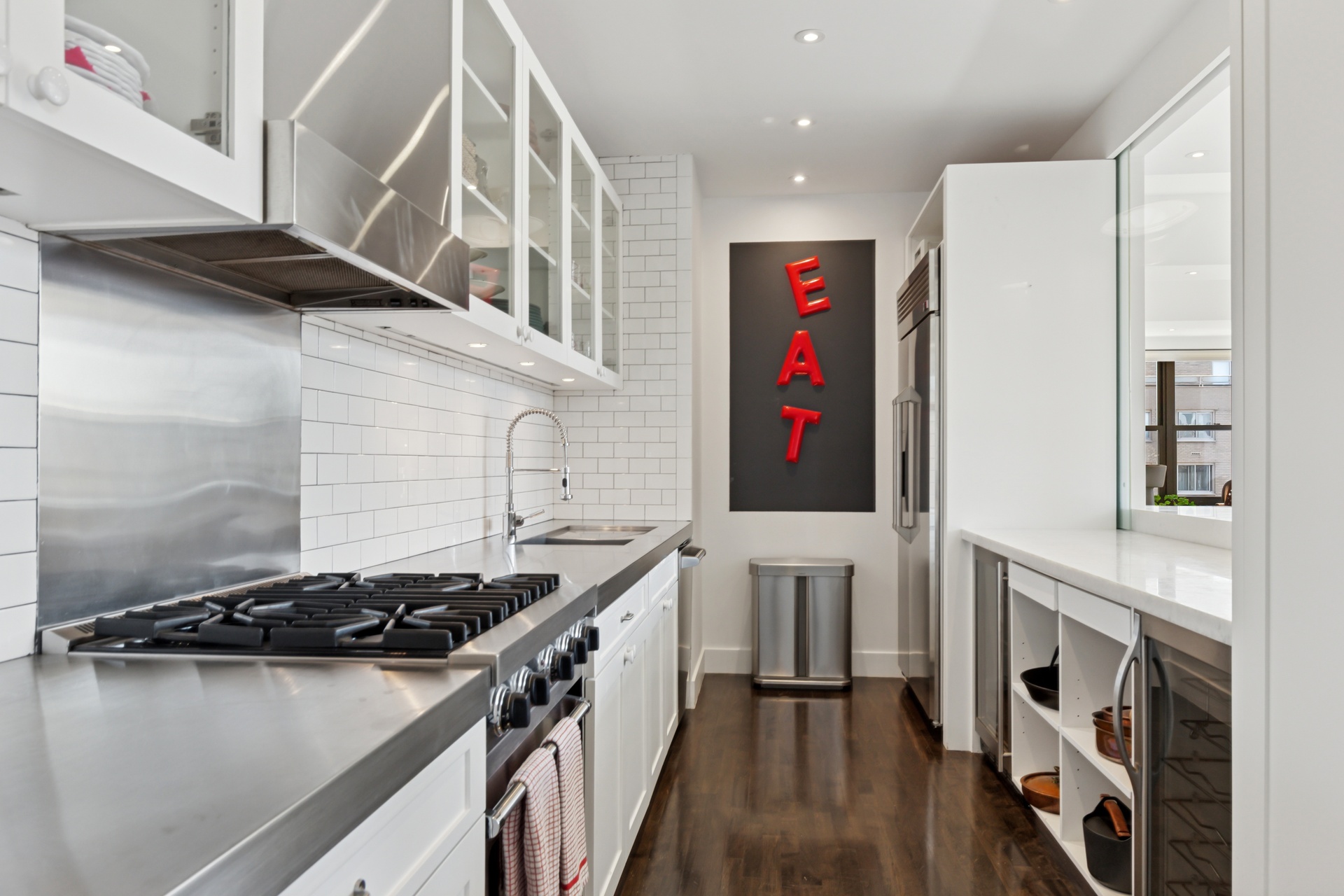65 West 13th Street, Unit PH1AB Manhattan, NY 10011 - Photo 8 of 27 a kitchen with stainless steel appliances granite countertop a stove and a refrigerator