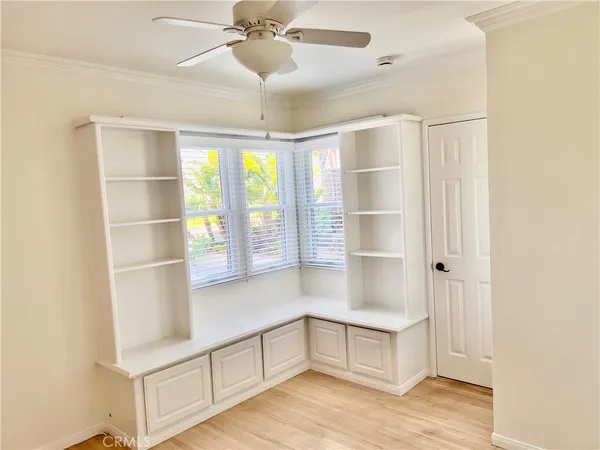a living room with stainless steel appliances cabinets and a large window