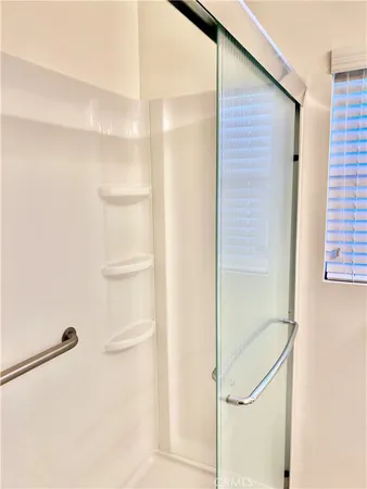a bathroom with a glass shower door