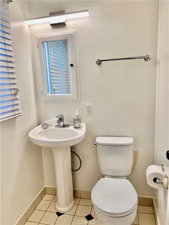 a white toilet sitting next to a bathroom sink