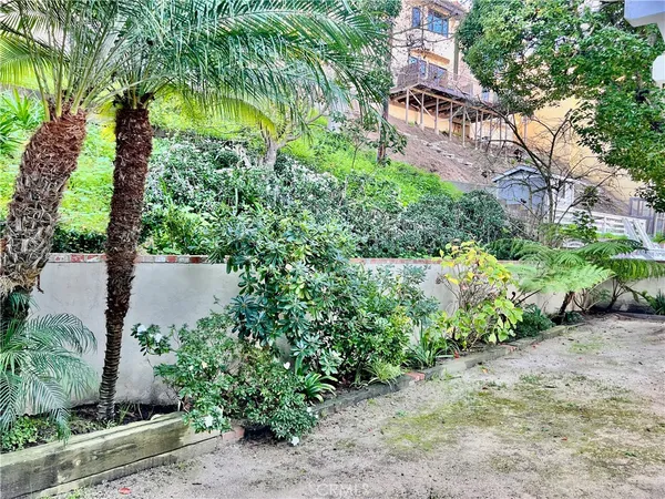 a backyard of a house with lots of green space and garden